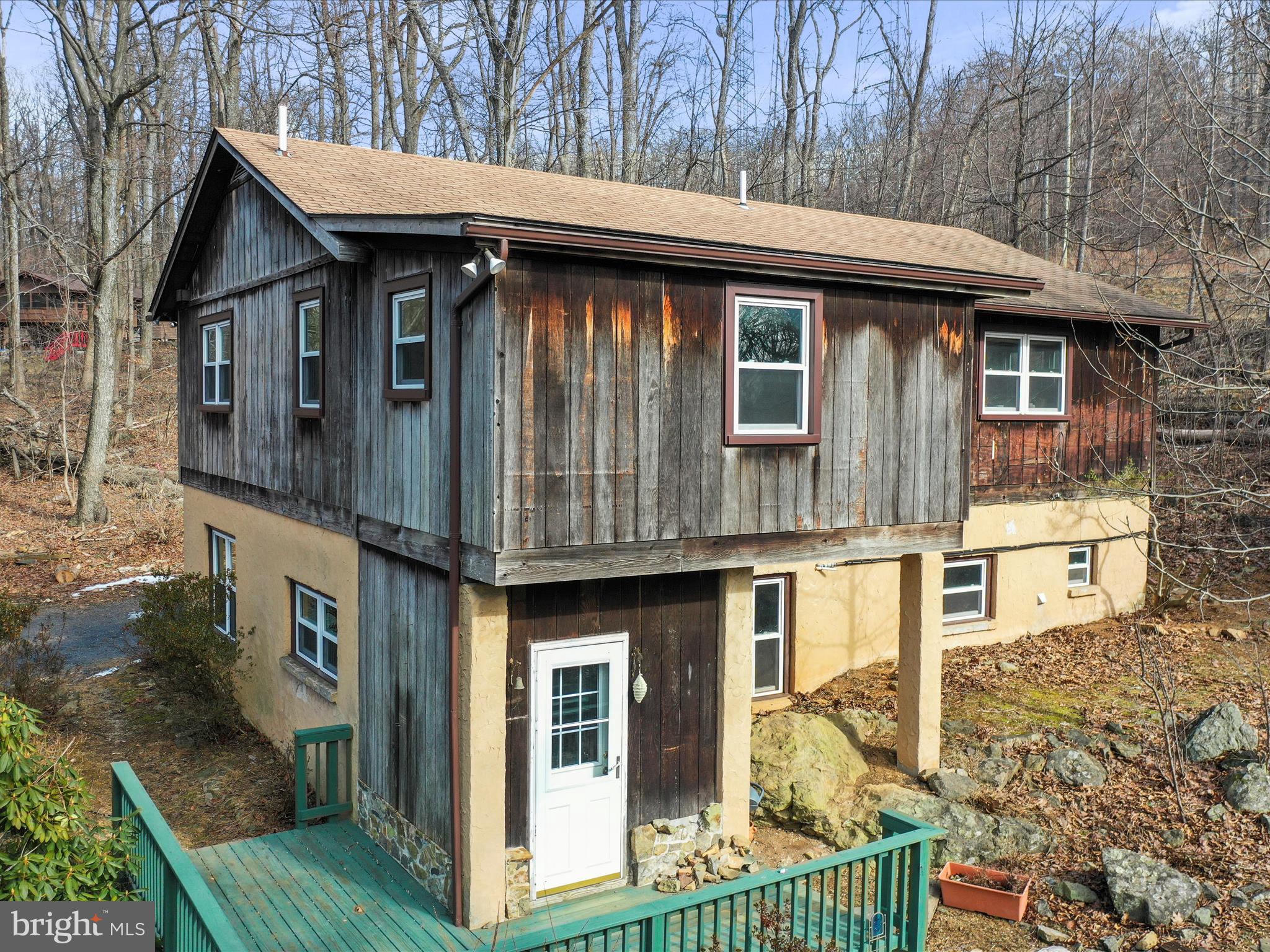 115 Old Log Road Linden, VA 22642 - Photo 2 of 8 a front view of a house with a yard table and chairs