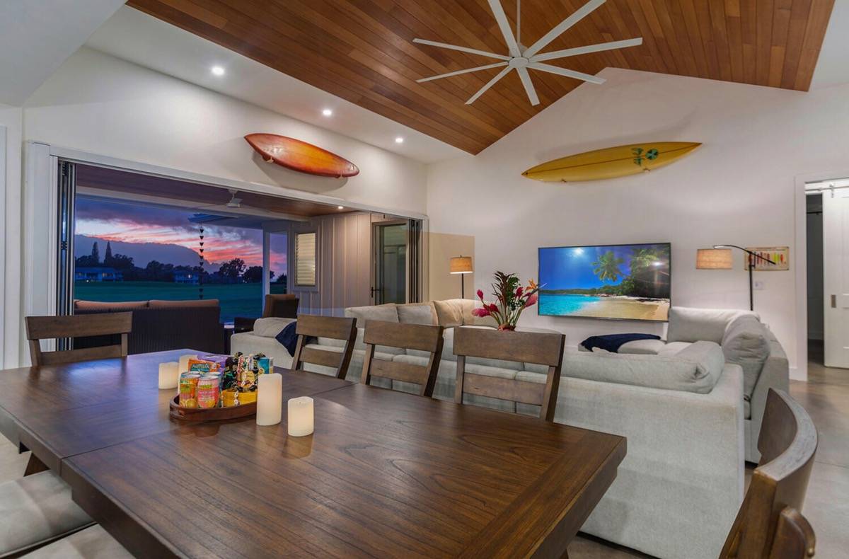a living room with furniture and a flat screen tv with wooden floor