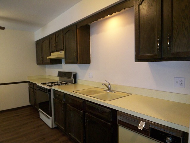 235 North Mill Road, Unit 106B Addison, IL 60101 - Photo 2 of 24 a kitchen with a sink a stove and cabinets