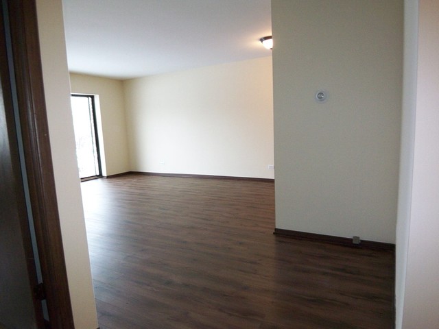 235 North Mill Road, Unit 106B Addison, IL 60101 - Photo 12 of 24 a view of a hallway with wooden floor