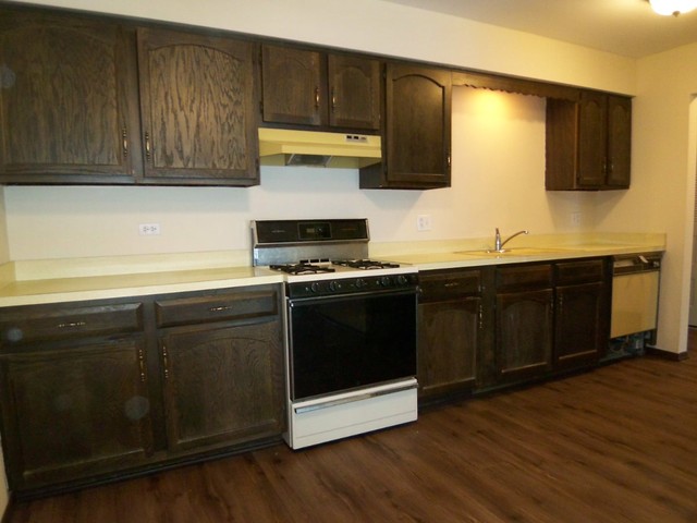 235 North Mill Road, Unit 106B Addison, IL 60101 - Photo 6 of 24 a kitchen with stainless steel appliances a stove a microwave a sink and cabinets