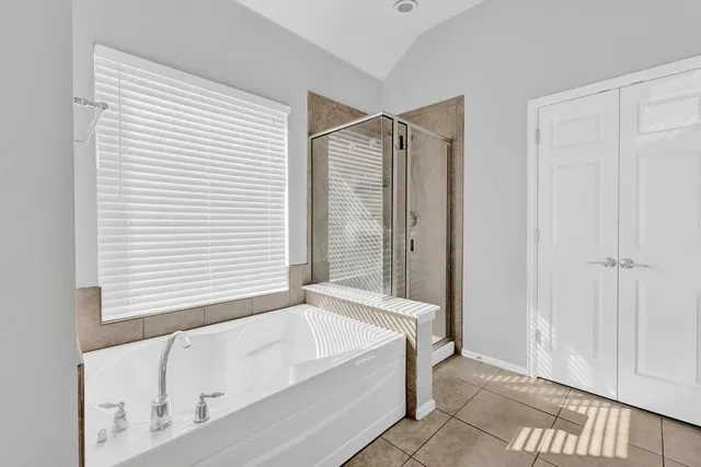 a bathroom with a bathtub and a shower