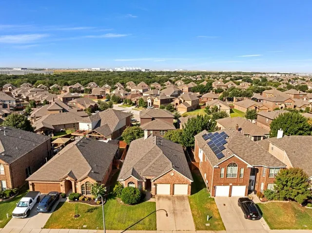 an aerial view of residential houses with outdoor space