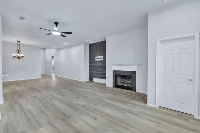 a view of an empty room with fire place and a fireplace