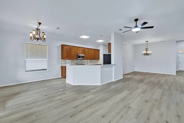 a view of a kitchen with a sink cabinet a microwave and cabinets
