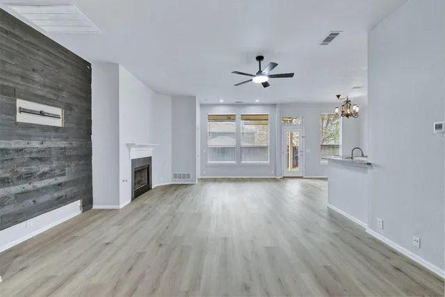 wooden floor in an empty room with a fireplace