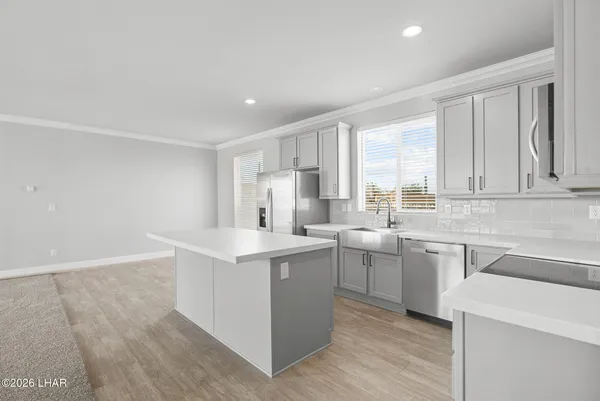 a kitchen with a sink stove and cabinets