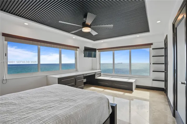 a bedroom with a large bed and a large window