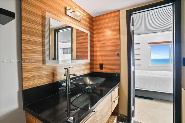 a kitchen with a sink and a wooden floor