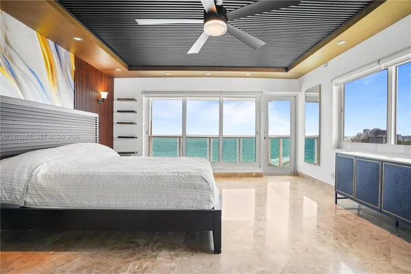 a bedroom with a large bed and a large window