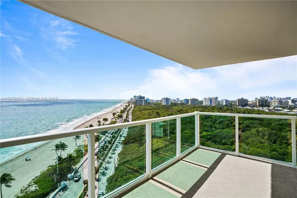 a view of a balcony with yard