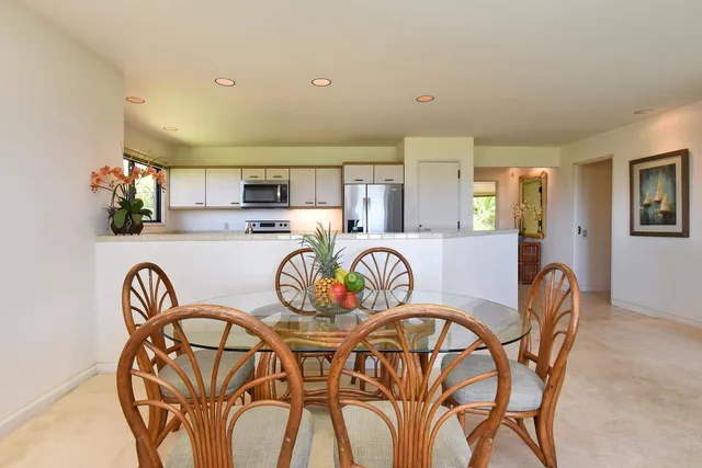 a dining room with furniture and wooden floor