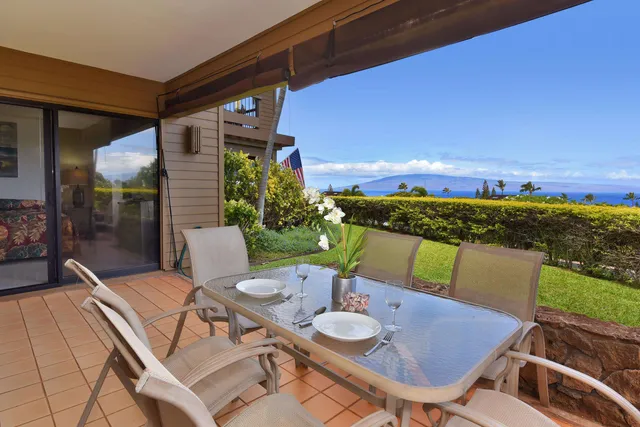 a view of a balcony with table and chairs