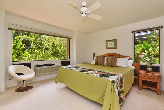 a bedroom with a bed and a large window