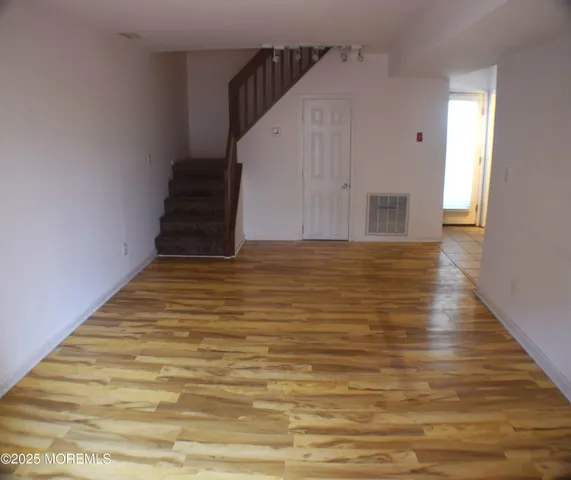 a view of entryway with wooden floor