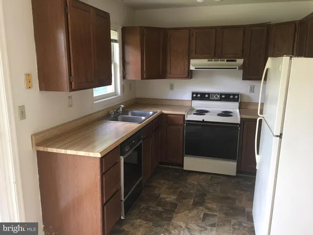 a kitchen with a sink a stove and refrigerator