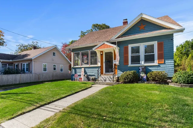 a front view of a house with a yard and porch