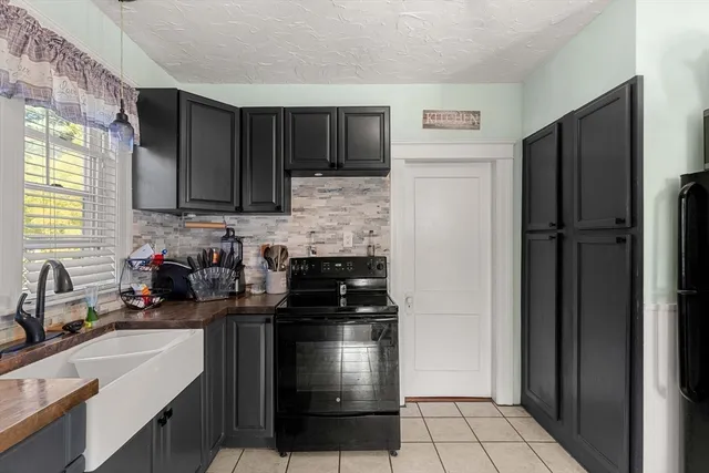 a kitchen with a sink stove and refrigerator