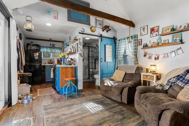 a living room with furniture a air conditioner vent and a rug