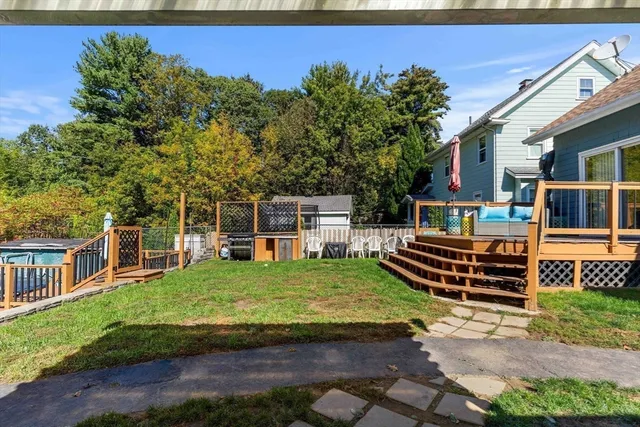a view of a yard with wooden fence