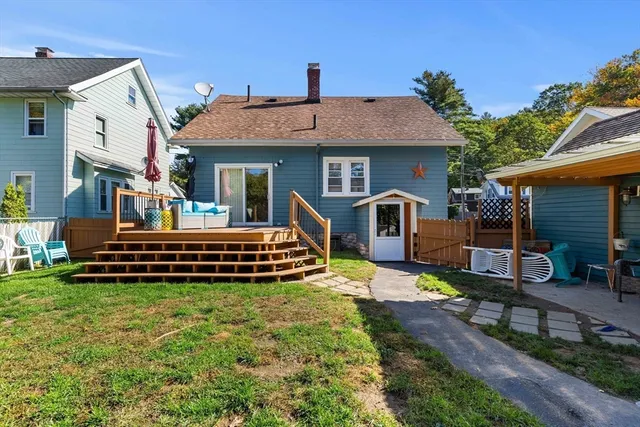 a view of a house with a yard and furniture