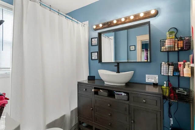 a living room with furniture and a mirror