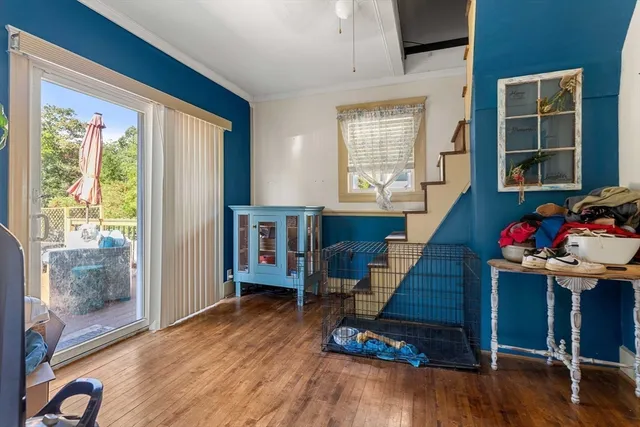 a view of a livingroom with wooden floor and furniture