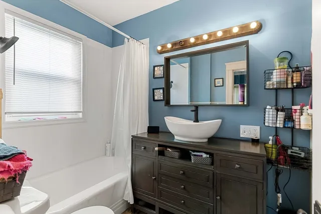 a living room with furniture and a mirror