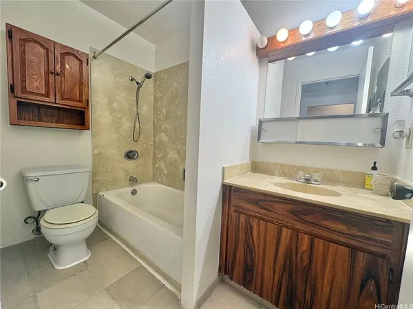 a bathroom with a sink a toilet and bathtub