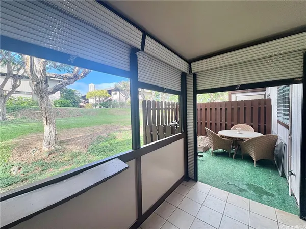 a view of a porch with furniture and garden