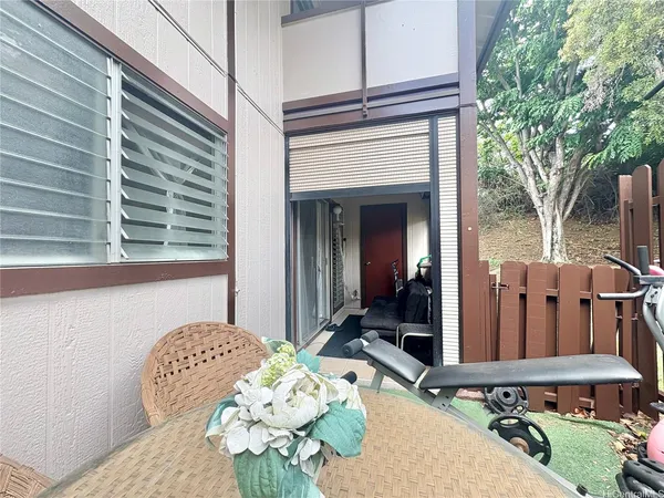 a view of balcony with two chairs and a table