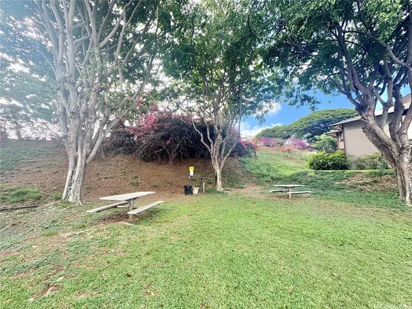 a backyard of a house with table and chairs