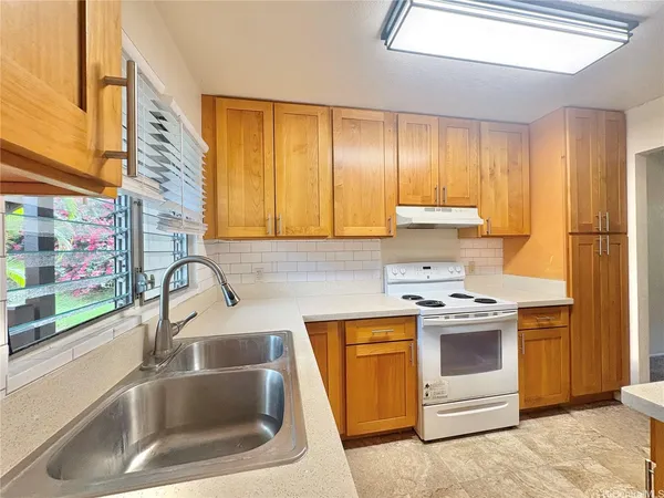 a kitchen with a sink and a stove top oven