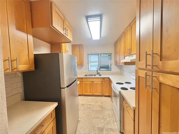 a kitchen with a refrigerator and a more cabinets