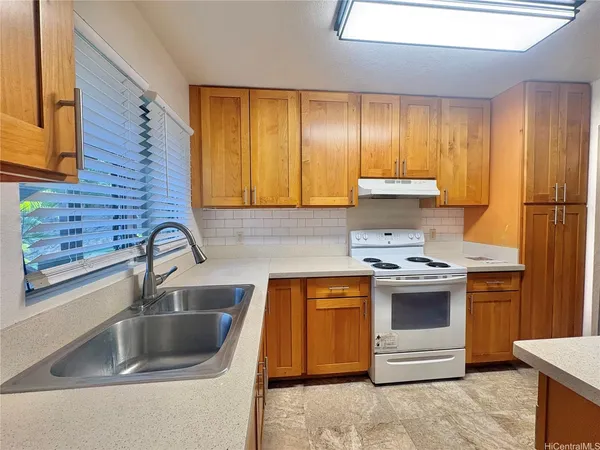 a kitchen with a sink stove top oven and cabinets