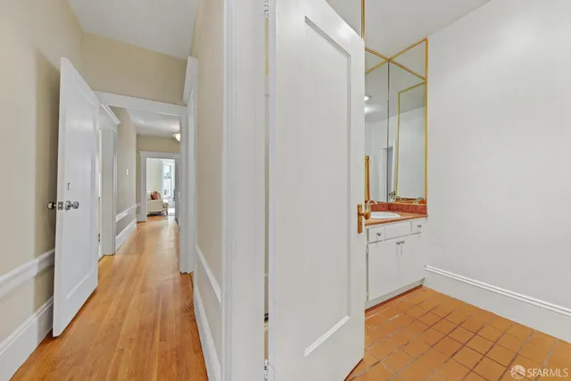 a view of a dining room with furniture a chandelier and wooden floor