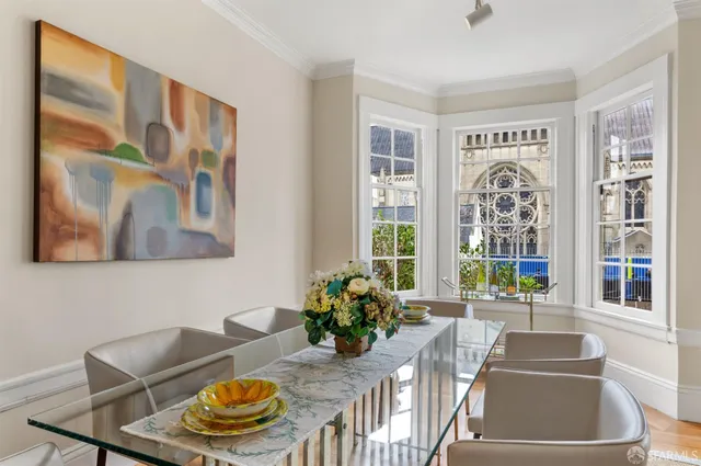 a view of a white building among the street with palm trees