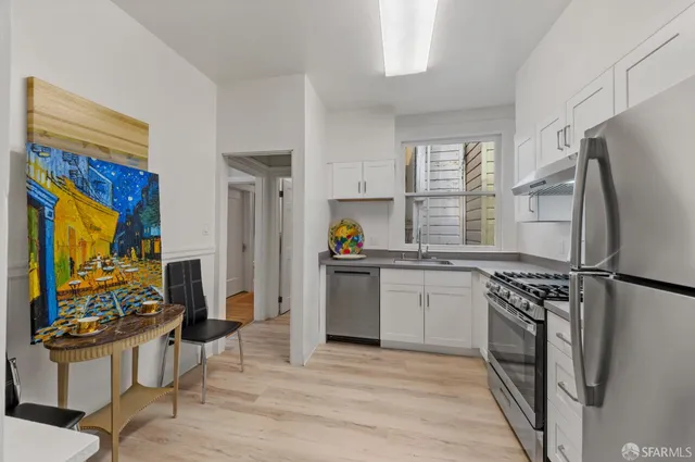 a view of a hallway with wooden floor and entryway