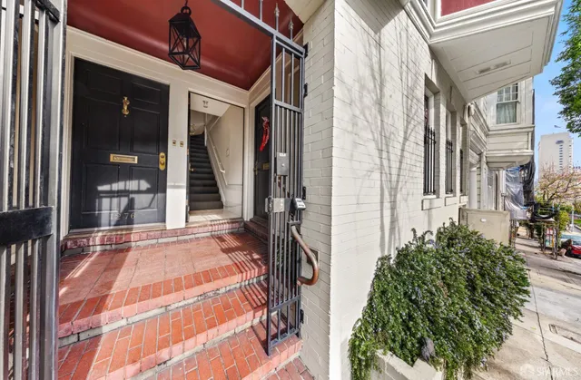 a dining room with wooden floor and a floor to ceiling window