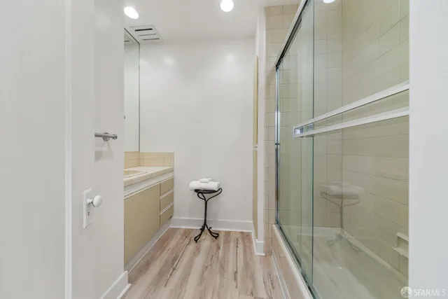 a dining room with furniture a rug a potted plant and a window