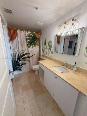 a bathroom with a sink a mirror and vanity