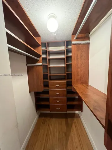 a view of walk in closet with empty racks