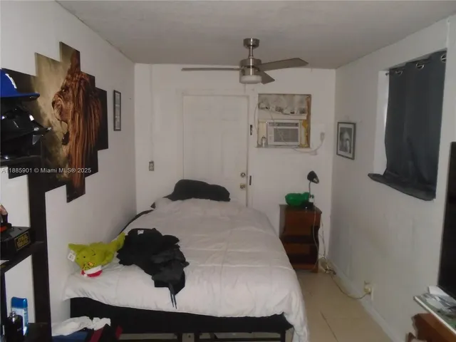 a bedroom with a bed and a flat tv screen