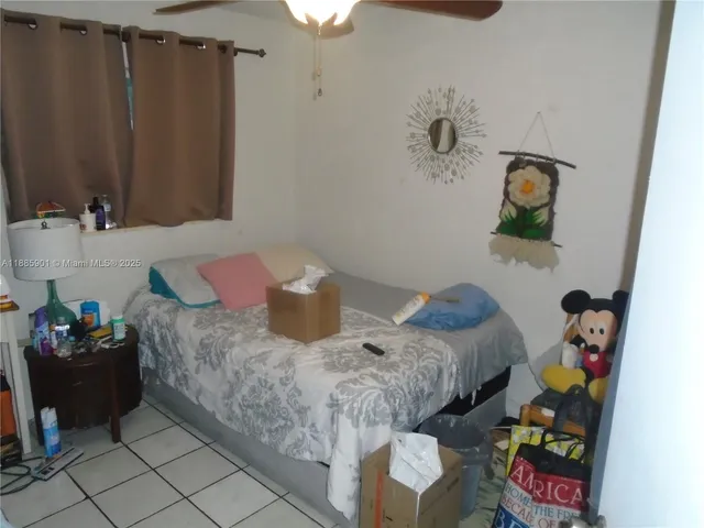 a kitchen with lots of clutter and cabinets