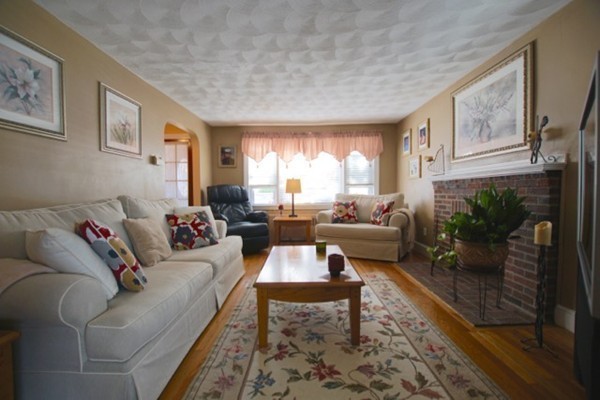 49 Faywood Avenue Boston, MA 02128 - Photo 11 of 30 a living room with furniture and a fireplace