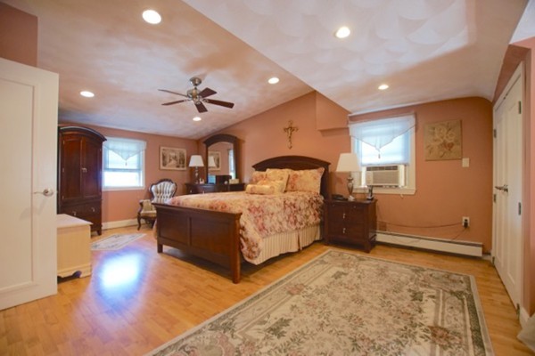 49 Faywood Avenue Boston, MA 02128 - Photo 18 of 30 a bedroom with a bed and a chandelier