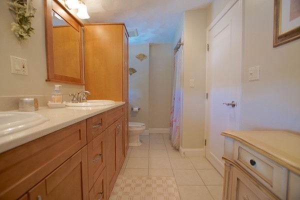 49 Faywood Avenue Boston, MA 02128 - Photo 20 of 30 a spacious bathroom with a double vanity sink a toilet and a mirror