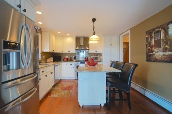 49 Faywood Avenue Boston, MA 02128 - Photo 2 of 30 a kitchen with white cabinets and stainless steel appliances