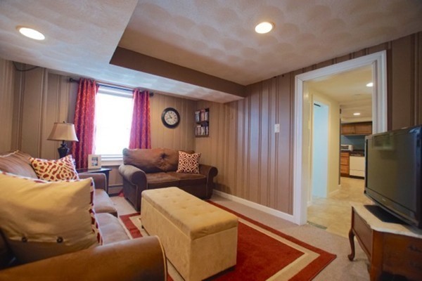 49 Faywood Avenue Boston, MA 02128 - Photo 26 of 30 a living room with furniture and a flat screen tv