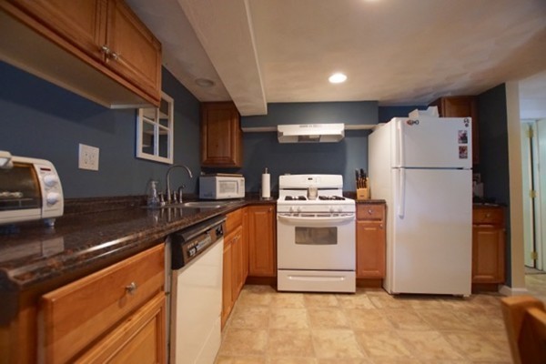 49 Faywood Avenue Boston, MA 02128 - Photo 27 of 30 a kitchen with a refrigerator sink stove and cabinets